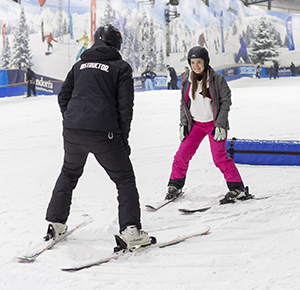 Image shows a novice skier in a skiing lesson at the Snowdome